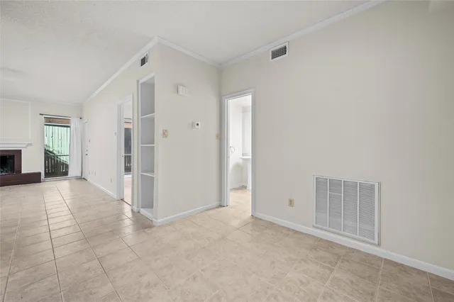 an empty room with windows and wardrobe