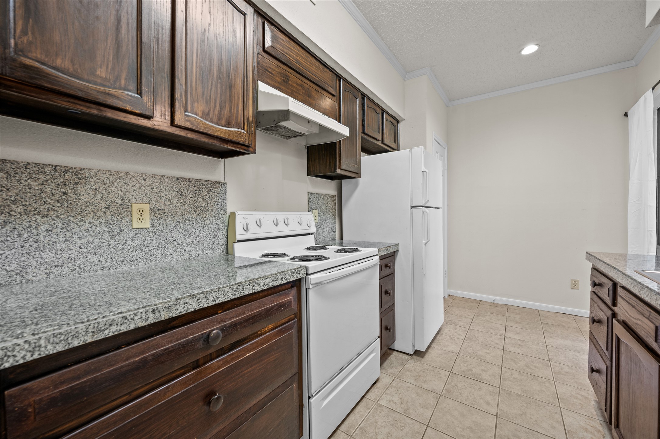 5718 Val Verde Street, Unit 7 Houston, TX 77057 - Photo 6 of 23 a kitchen with stainless steel appliances granite countertop a refrigerator and a stove
