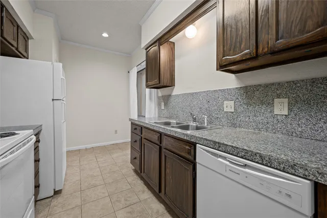 a kitchen with stainless steel appliances granite countertop a sink and a stove