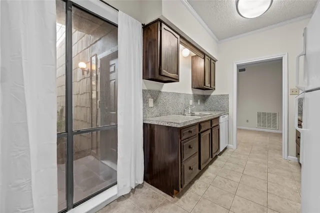 a bathroom with a granite countertop double vanity sink and a mirror