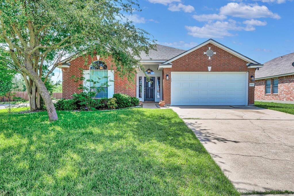10140 China Creek Drive Waco, TX 76708 - Photo 1 of 1 a front view of a house with a yard and garage