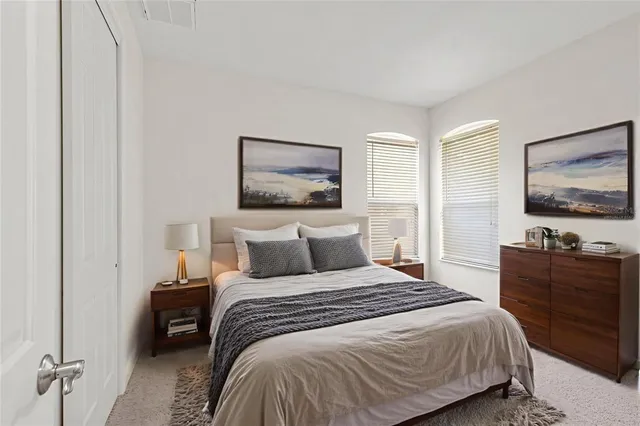 a front view of a house with a garden and yard