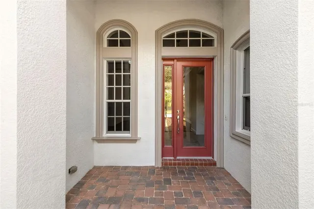 a view of a hallway with wooden floor and closet area