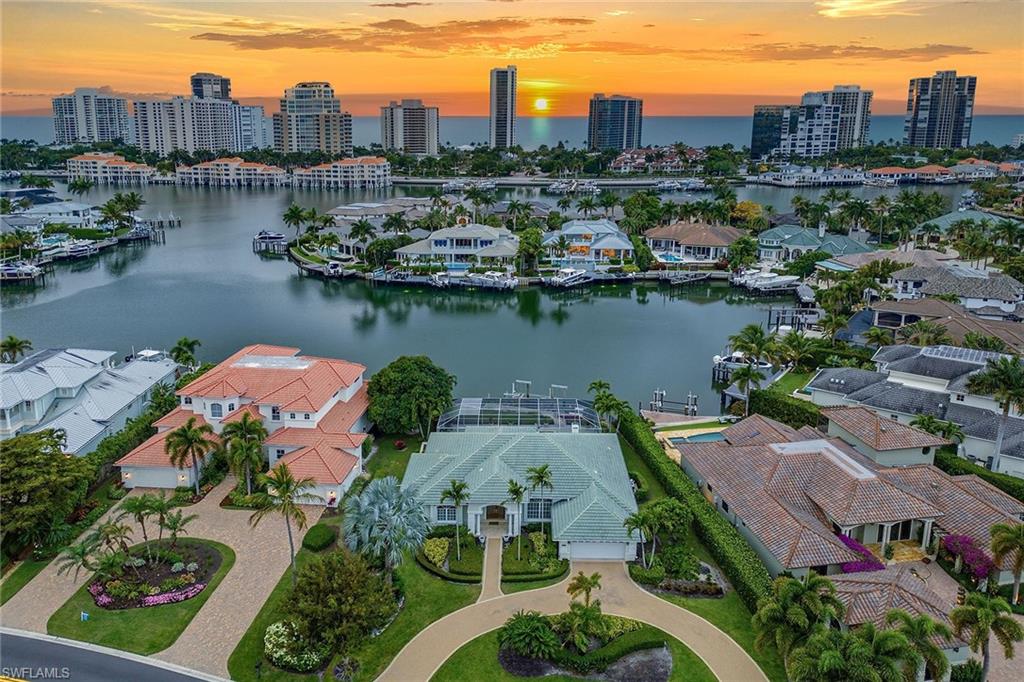 an aerial view of residential houses with outdoor space and lake view
