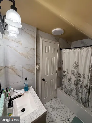 a bathroom with a sink a toilet and shower curtain