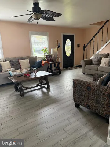 a living room with furniture a rug and a window