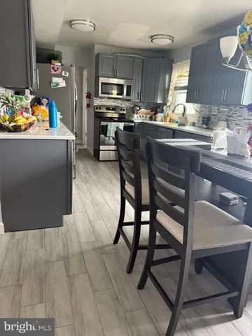 a kitchen with stainless steel appliances kitchen island granite countertop a sink and cabinets