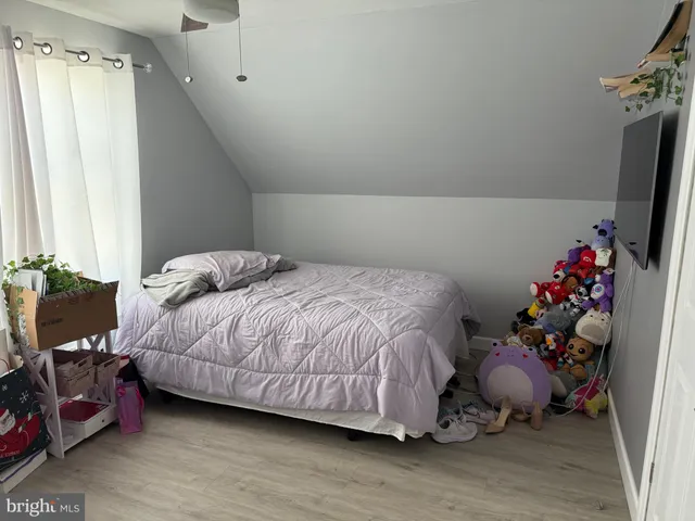 a bedroom with a bed and a potted plant