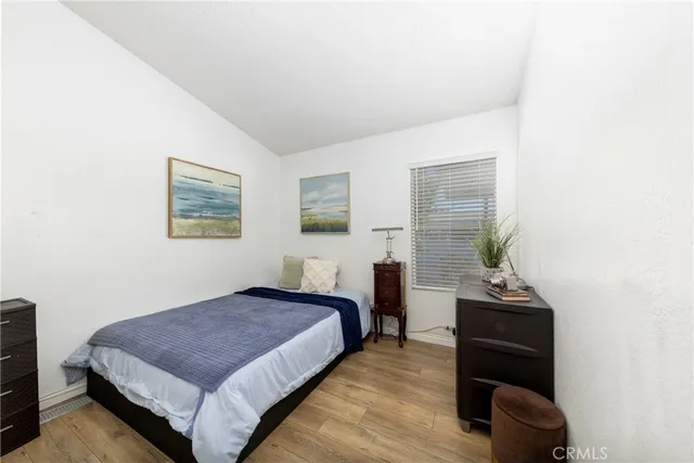 a bedroom with a bed and a chair