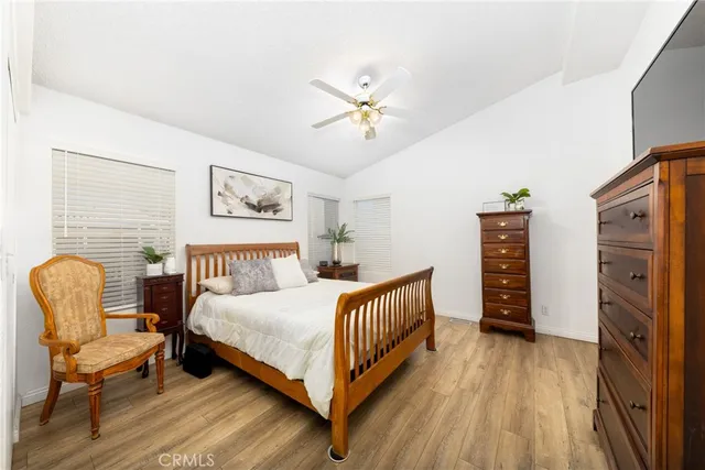 a bedroom with furniture and a wooden floor