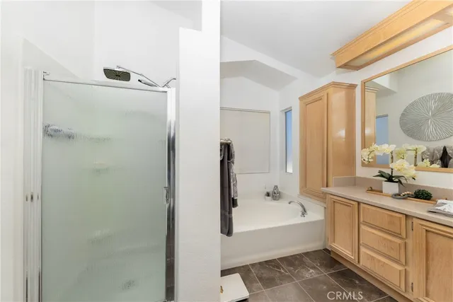 a bathroom with a tub sink and mirror