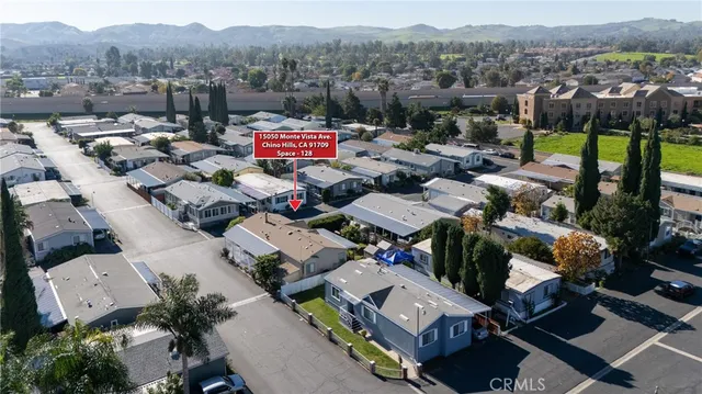 an aerial view of residential houses with yard