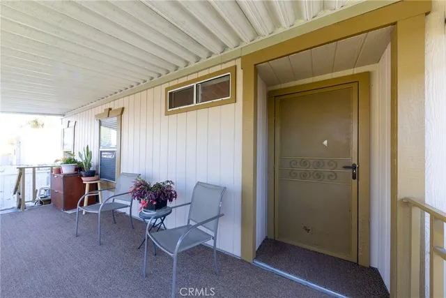a balcony with furniture and potted plants