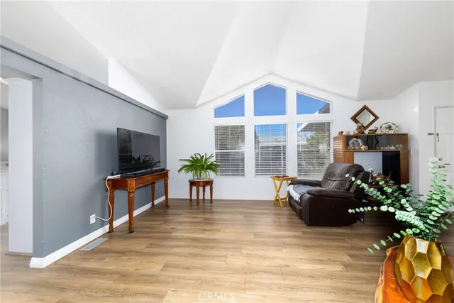 a living room with furniture windows and wooden floor