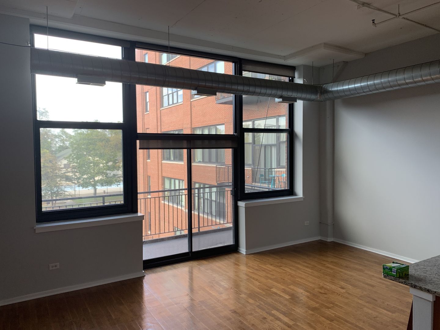 2323 West Pershing Road, Unit 319 Chicago, IL 60609 - Photo 11 of 39 an empty room with wooden floor and windows
