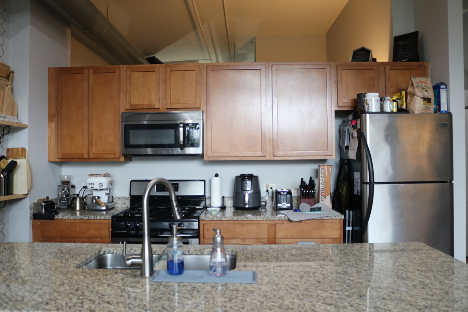 2323 West Pershing Road, Unit 319 Chicago, IL 60609 - Photo 13 of 39 a kitchen with stainless steel appliances granite countertop a refrigerator and a stove top oven