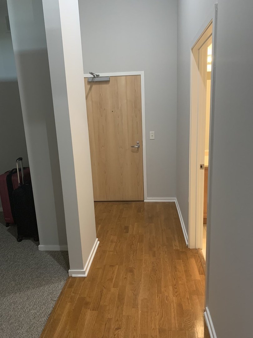 2323 West Pershing Road, Unit 319 Chicago, IL 60609 - Photo 21 of 39 a view of a room with wooden floor and sliding door