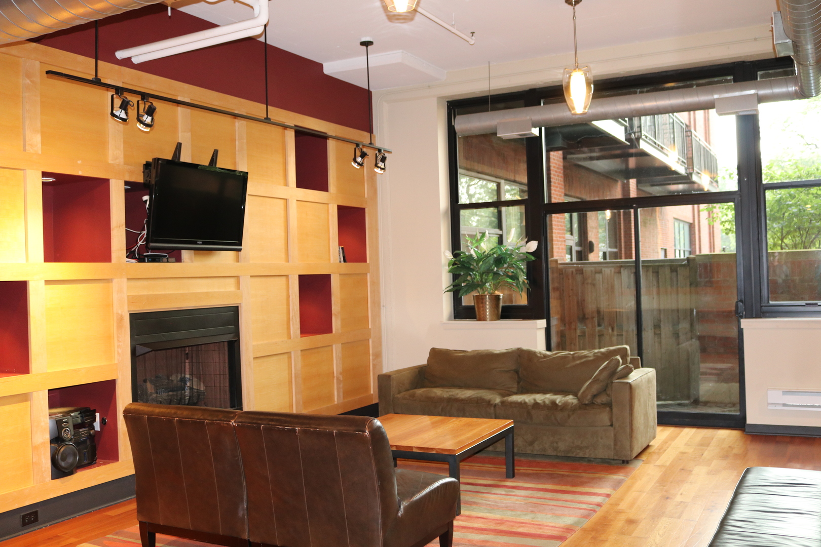 2323 West Pershing Road, Unit 319 Chicago, IL 60609 - Photo 35 of 39 a living room with furniture a flat screen tv and a fireplace