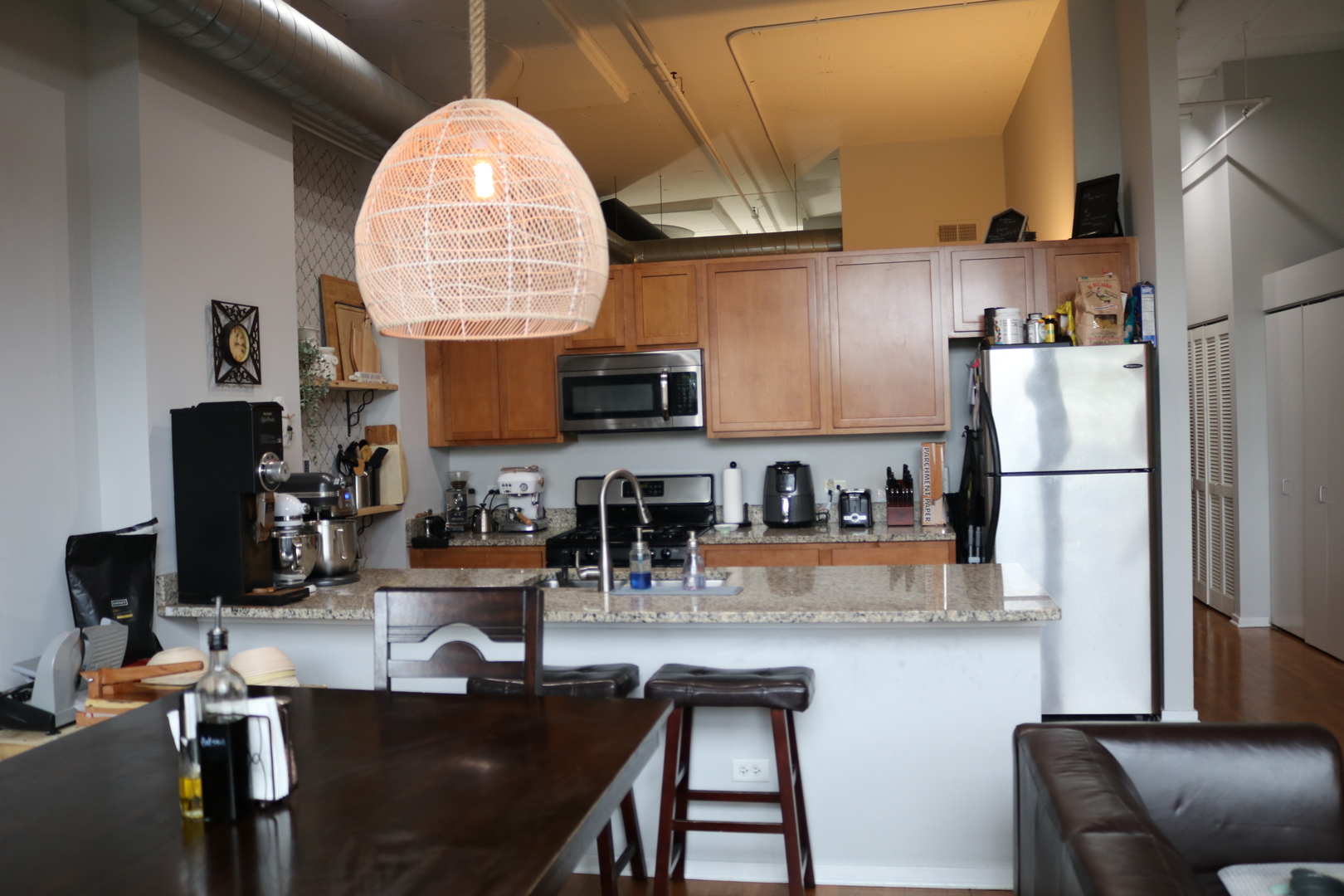 2323 West Pershing Road, Unit 319 Chicago, IL 60609 - Photo 7 of 39 a kitchen with refrigerator and chairs