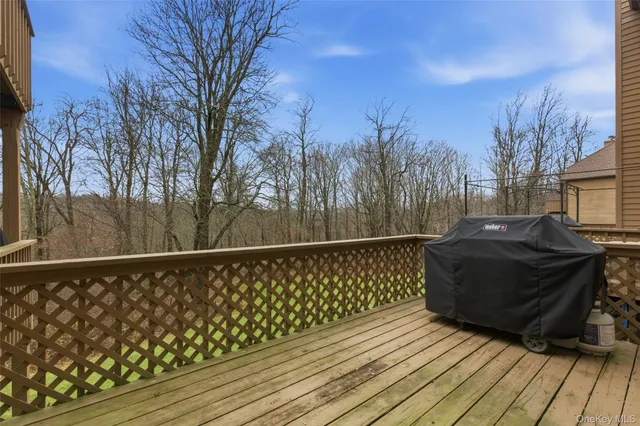 a view of a roof deck with wooden floor and fence