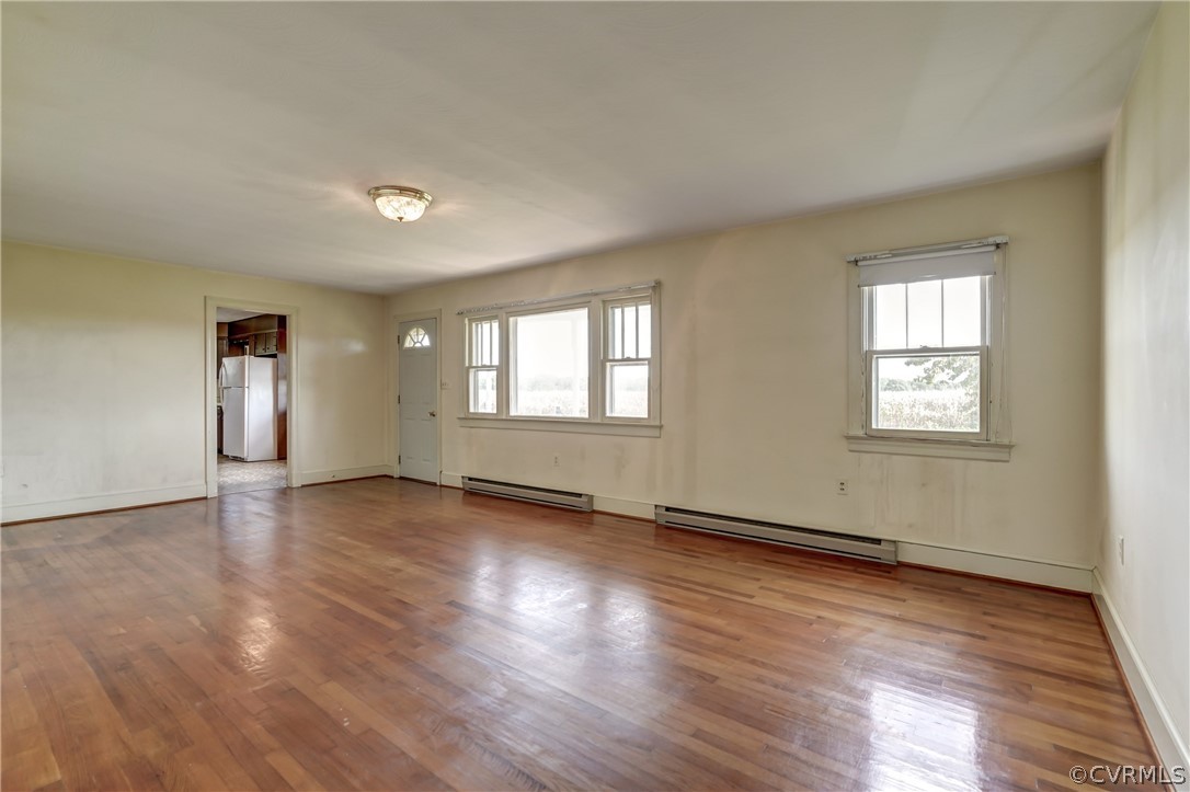 121 John Randolph Road Farmville, VA 23901 - Photo 36 of 46 an empty room with wooden floor and windows