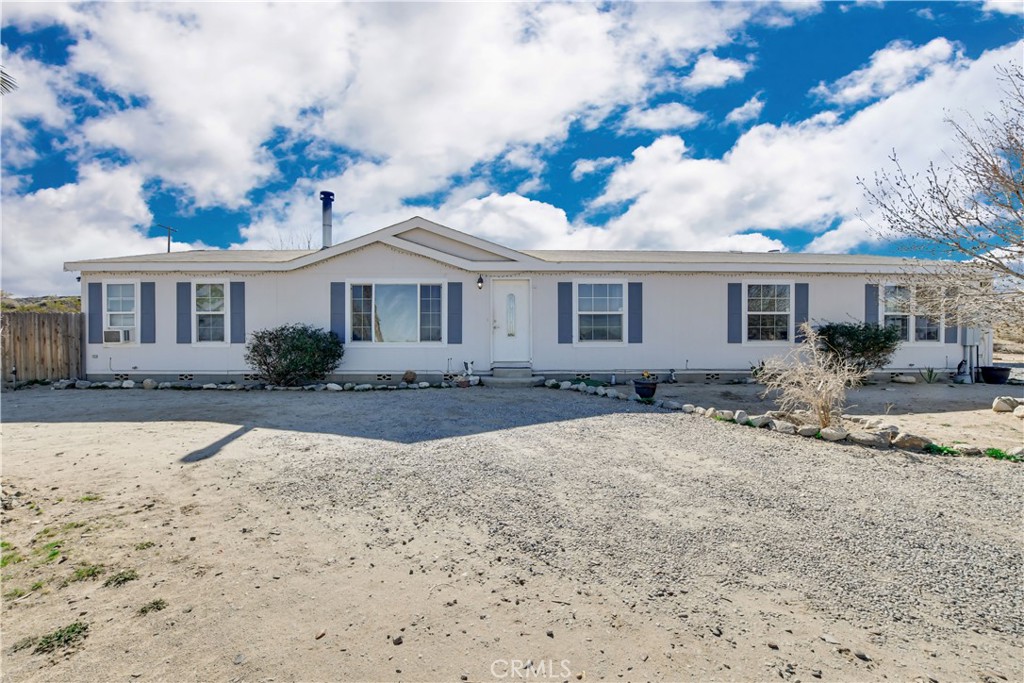 13094 Primavera Road Pinon Hills, CA 92372 - Photo 1 of 1 a front view of a house with a yard
