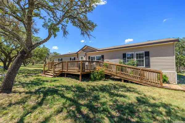 a view of a house with wooden fence