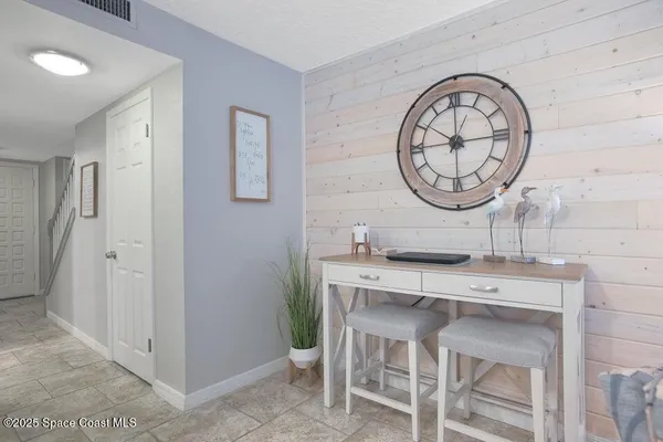 a room with a table a clock and a clock