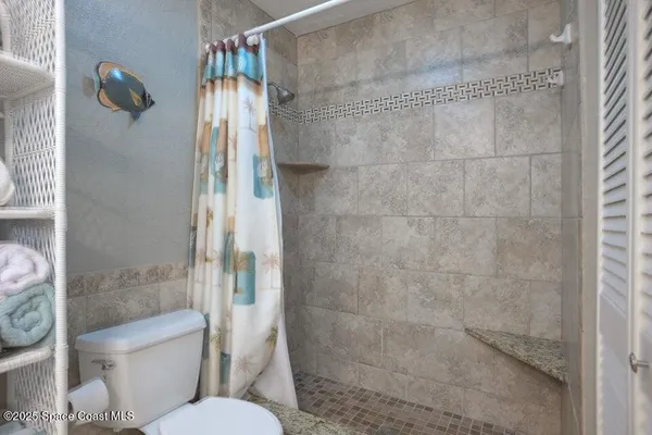 a bathroom with a toilet and shower