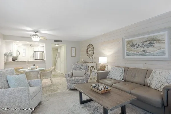 a living room with furniture a rug and a chandelier