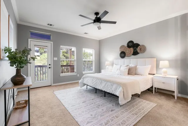a bedroom with a large bed and a chandelier