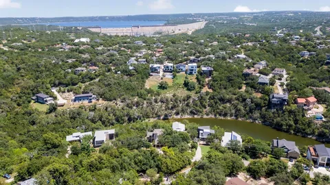 an aerial view of residential house with outdoor space and trees around