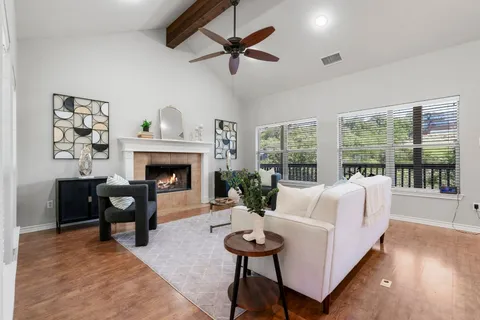 a living room with furniture a table and a fireplace