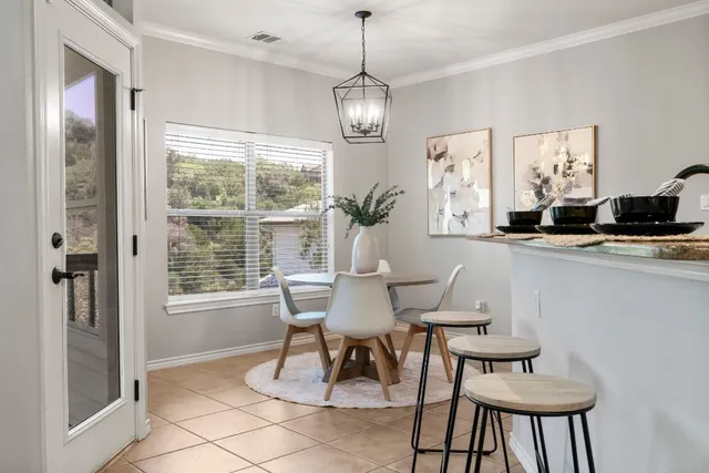 a dining room with furniture a chandelier and window