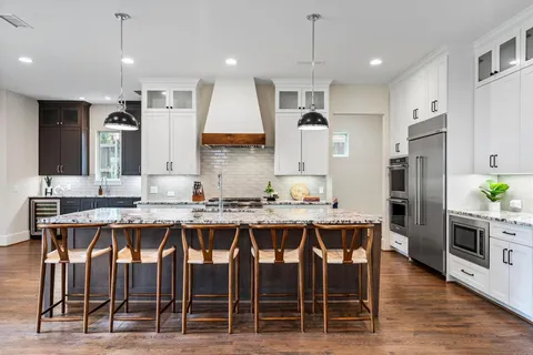 a large kitchen with a table and chairs