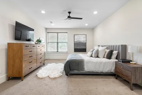 a bedroom with a bed and flat screen tv
