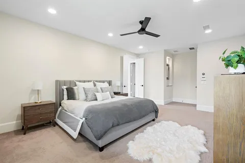 a bedroom with a bed and a ceiling fan