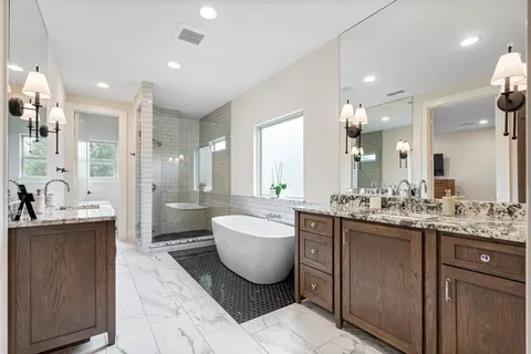 a bathroom with a granite countertop sink a toilet and mirror