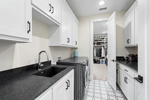 a kitchen with stainless steel appliances granite countertop a sink stove refrigerator and cabinets