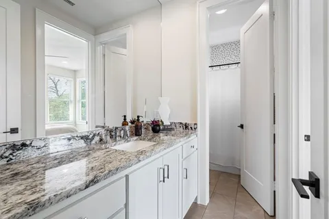 a bathroom with double sink and a mirror