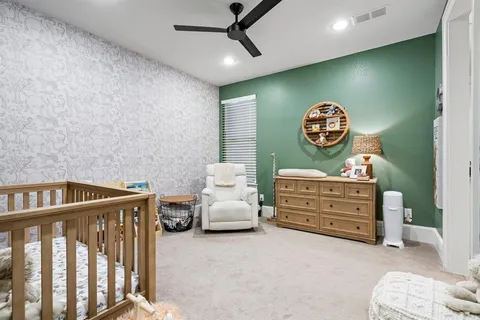 a bedroom with furniture and a fan