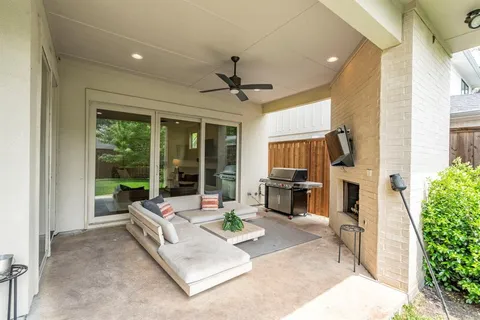 a living room with fireplace furniture and a floor to ceiling window