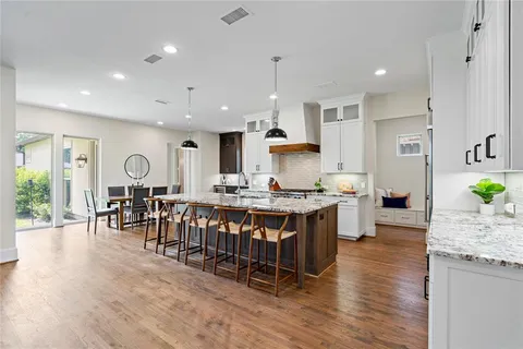 a large kitchen with lots of counter space and furniture