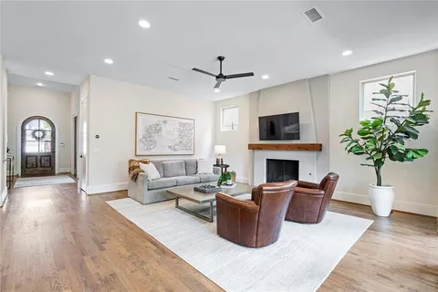 a living room with furniture a fireplace and a potted plant