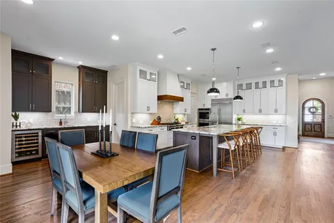 a large kitchen with a table and chairs