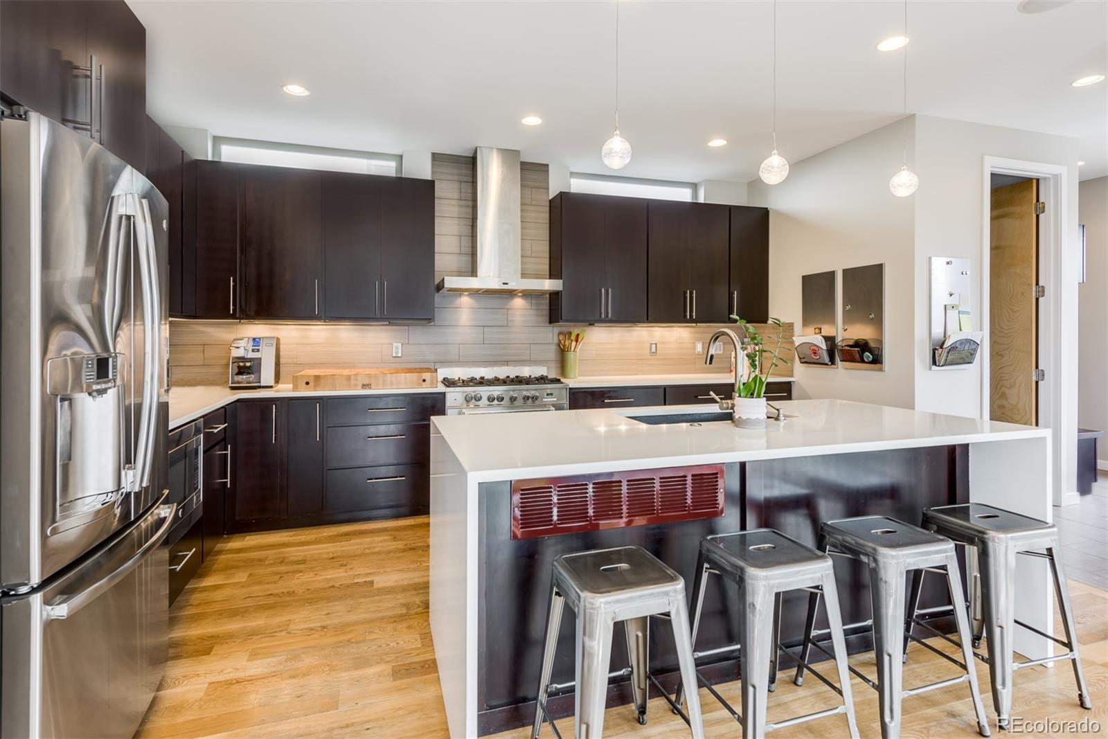 4030 Bryant Street Denver, CO 80211 - Photo 11 of 26 a kitchen with cabinets and chairs