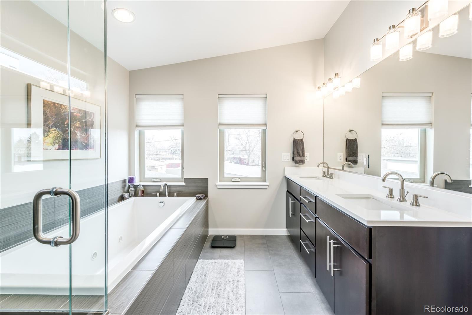4030 Bryant Street Denver, CO 80211 - Photo 15 of 26 a spacious bathroom with a tub sink and mirror