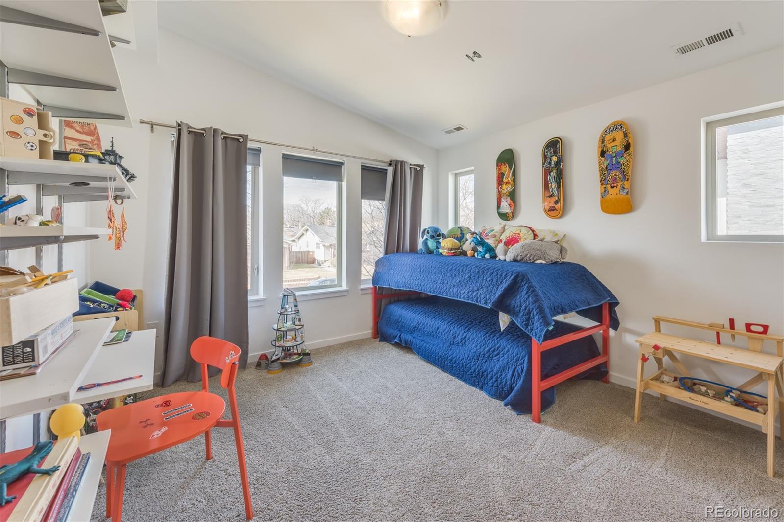 4030 Bryant Street Denver, CO 80211 - Photo 18 of 26 a living room with furniture and a book shelf