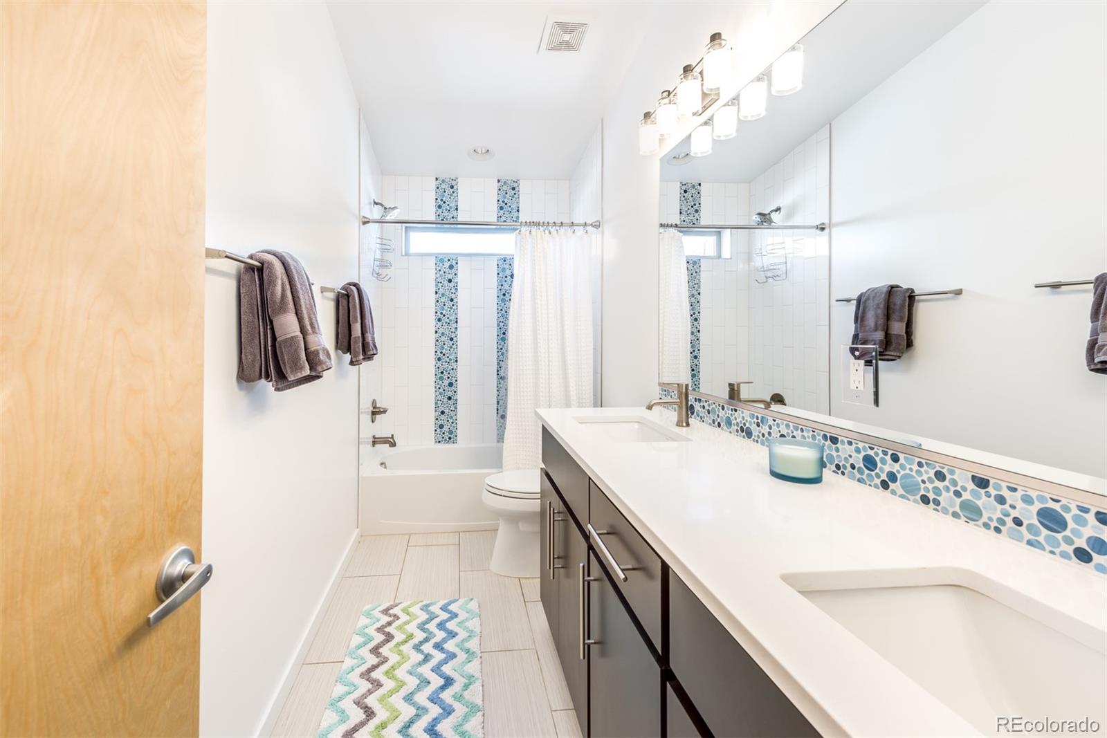 4030 Bryant Street Denver, CO 80211 - Photo 19 of 26 a bathroom with a sink double vanity and shower