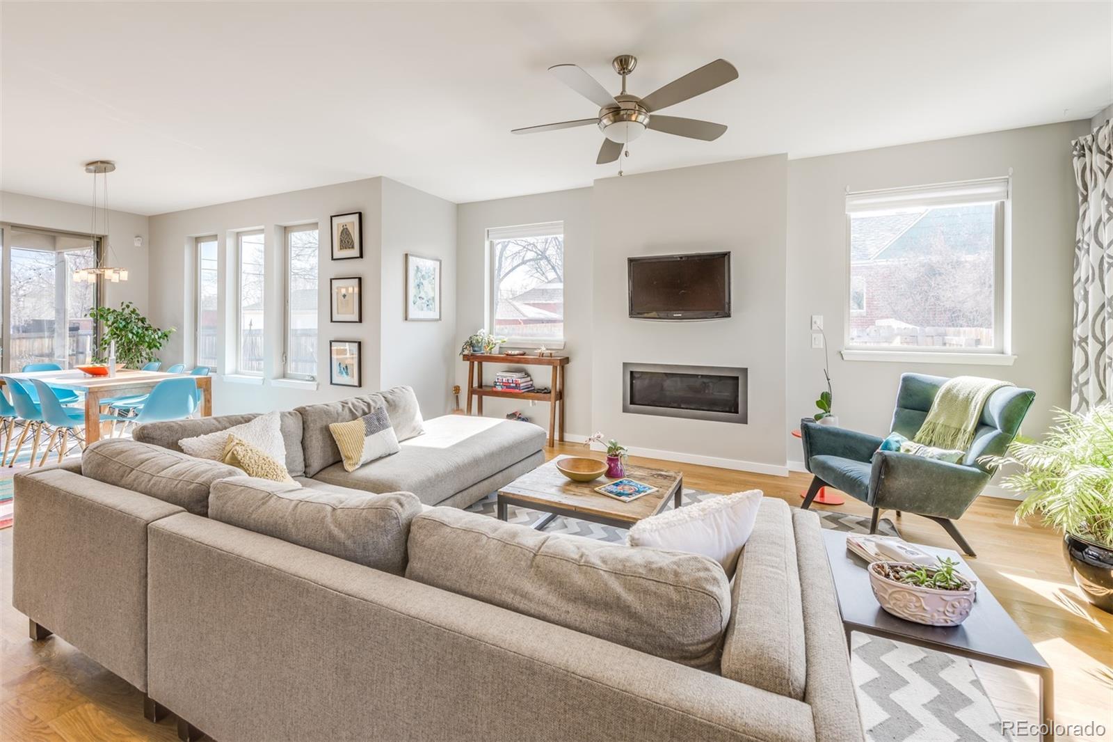 4030 Bryant Street Denver, CO 80211 - Photo 2 of 26 a living room with furniture a flat screen tv and a fireplace